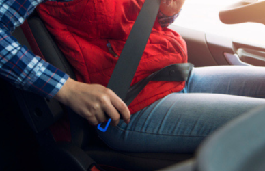 female trucker buckling seat belt