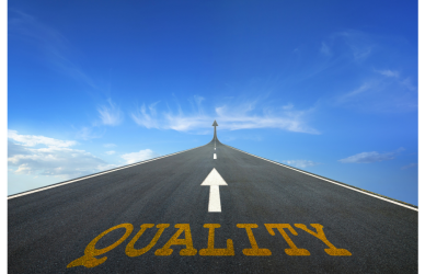 The word "quality" written on the road with an arrow pointing up.