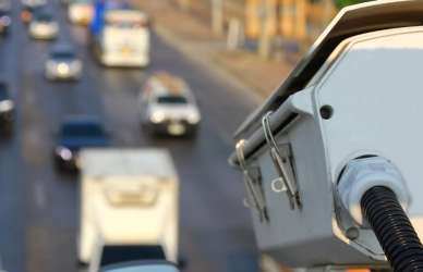 traffic camera pointing at road full of vehicles