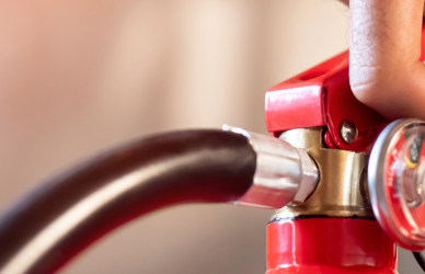 Hand holding fire extinguisher