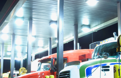 semi trucks parked at truck stop fuel pumps