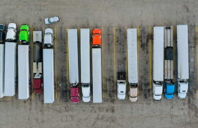 semi trucks parked in lot aerial