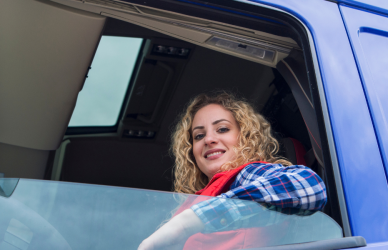 woman sitting in drivers seat of semi truck