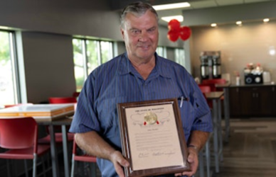 john moeller holding his 6 million mile plaque