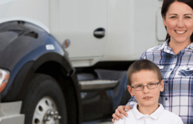 Mom with son in front of semi truck