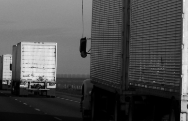 line of semi trucks on highway