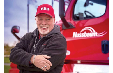 Clark Reed posing next to his Nussbaum semi truck