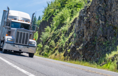 semi truck driving on mountain road