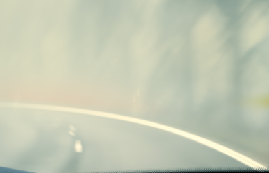 semi truck driving on foggy road with alert in corner of windshield