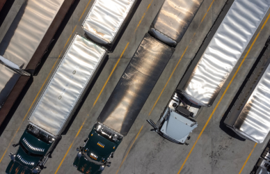 several semi trucks in parking lot aerial view