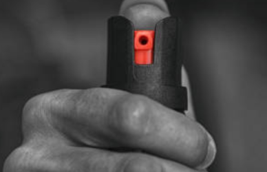 Man holding can of mace