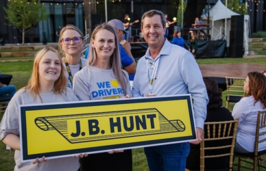 J.B Hunt employees holding J.B. Hunt sign