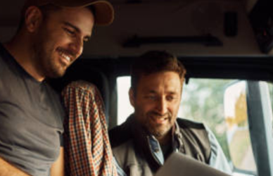 two men in the cab of a semi truck