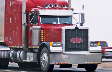 red semi truck with livestock trailer