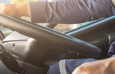 Truck driver behind the wheel of semi truck