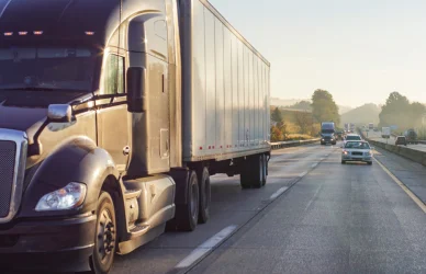semi truck in traffic on 4-lane road