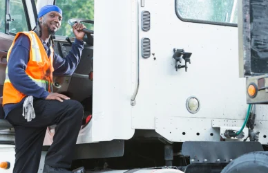 black man entering a semi truck cab