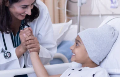 cancer patient child in hospital bed with nurse