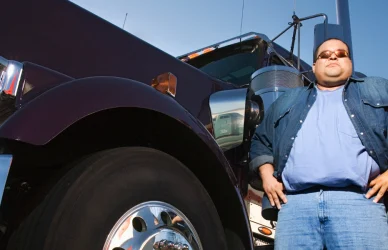 Man standing next to semi truck