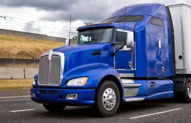 blue semi truck with white trailer with under guards