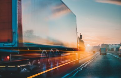 Semi Truck driving fast at dusk
