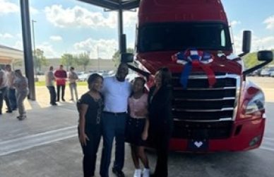 Ondrae Meyers and his family with the freightliner Cascadia truck he received from Progressive's keys to progress program