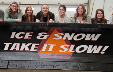 Wauseon High School students pose with their 2024 ODOT Paint-the Plow entry, "Ice & Snow, Take It Slow!"