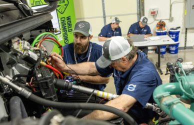 volvo service team working on semi truck diesel engine